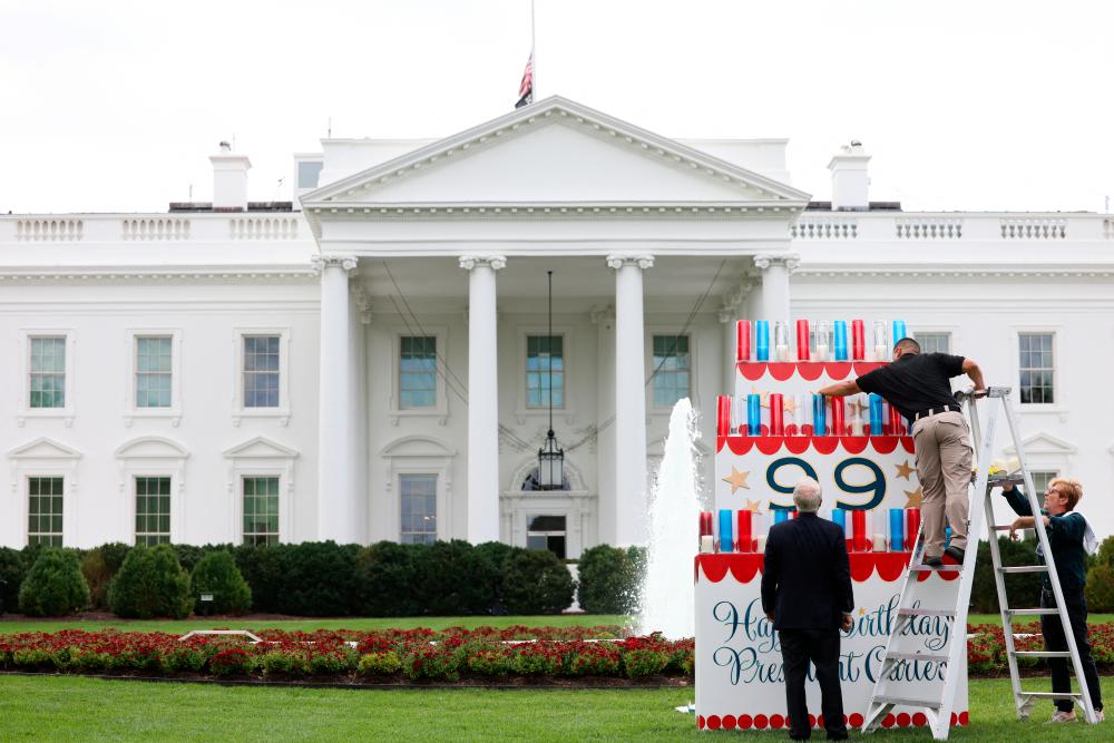 A White House electrician arranges 39 candles on a wooden birthday cake ahead of former US President Jimmy Carter’s 99th birthday on October 1, 2023 at the White House in Washington, US, September 30, 2023. REUTERSPIX