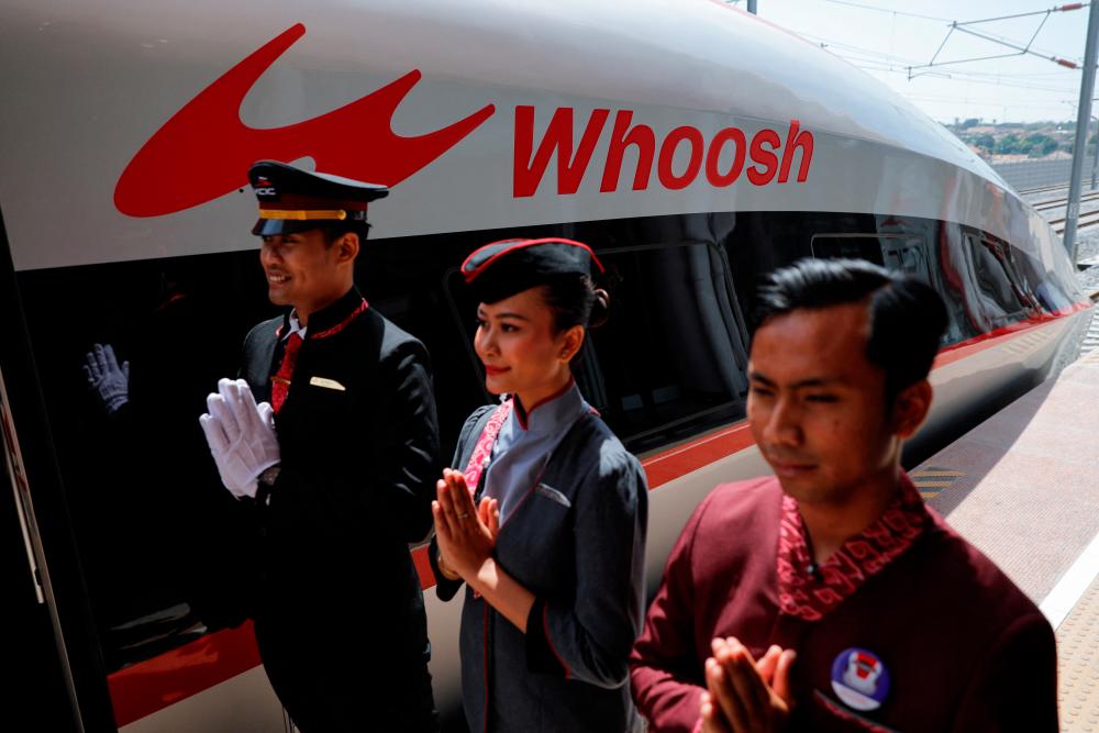 Staff stand to greet passengers of the China-backed high-speed railway connecting Jakarta and Bandung called “Whoosh”, as it parks at Padalarang station in West Java, Indonesia, October 2, 2023. REUTERSPIX