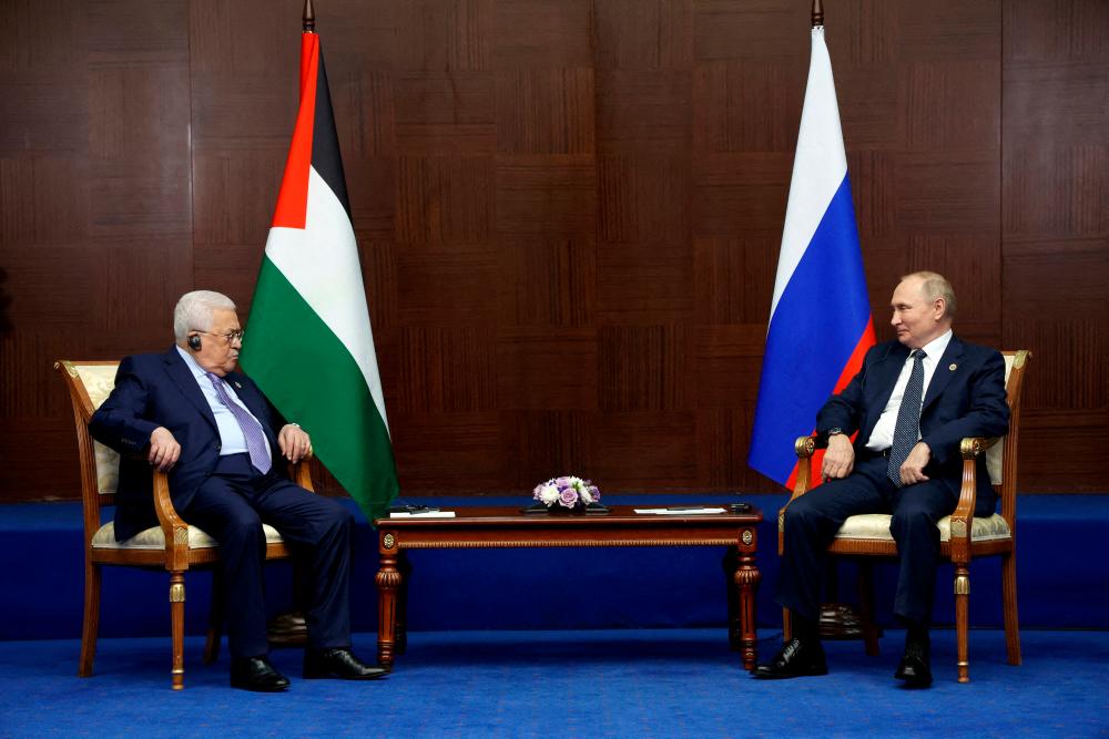 FILE PHOTO: Russia's President Vladimir Putin and Palestinian President Mahmoud Abbas meet on the sidelines of the 6th summit of the Conference on Interaction and Confidence-building Measures in Asia (CICA), in Astana, Kazakhstan October 13, 2022. REUTERSPIX