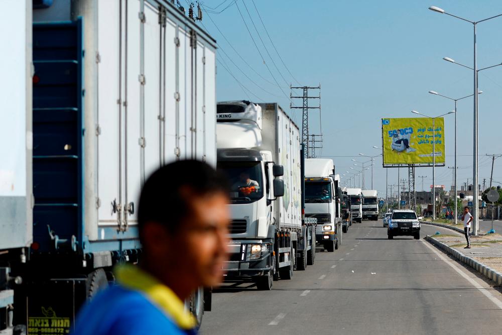 Trucks head to the Egyptian side of the border to be loaded with aid that will be delivered to Palestinians in Gaza, in Rafah in the southern Gaza Strip October 21, 2023. REUTERSPIX