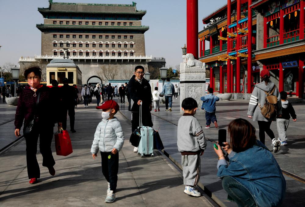 FILE PHOTO: People walk at a tourism site in Qianmen street, Beijing, China March 14, 2023. - REUTERSPIX