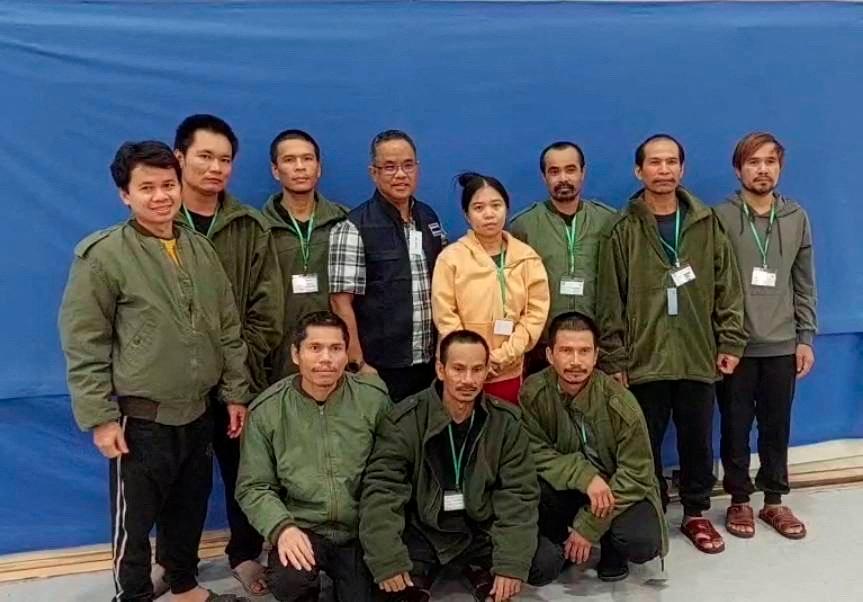 Thai workers taken hostage by Hamas and later released as part of a deal between Israel and Palestinian Islamist group Hamas, pose with a member of Thai mission after a medical checkup, in Tel Aviv, Israel - REUTERSPIX