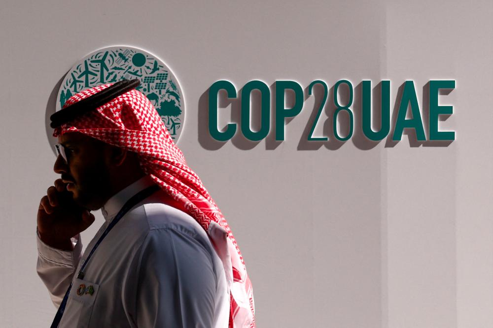 A man talks on the phone during the United Nations Climate Change Conference (COP28), in Dubai, United Arab Emirates, December 4, 2023. - REUTERSPIX