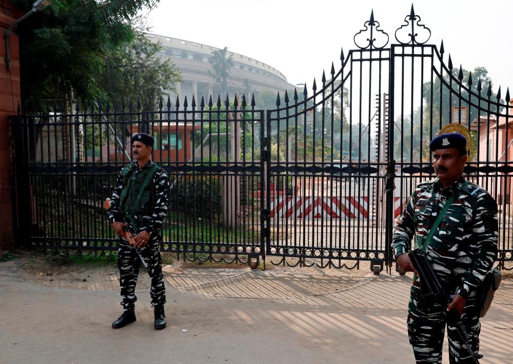 Security force personnel stand guard outside the parliament premises after a man jumped into the lawmakers’ area of the lower house of India’s parliament, in New Delhi, India, December 13, 2023/REUTERSPix