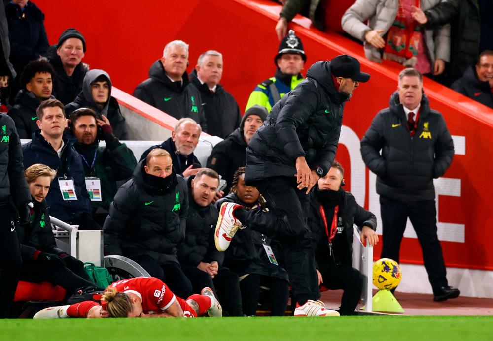 Football - Premier League - Liverpool v Arsenal - Anfield, Liverpool, Britain - December 23, 2023 Liverpool's Kostas Tsimikas after sustaining an injury as Liverpool manager Juergen Klopp reacts - REUTERSPIX