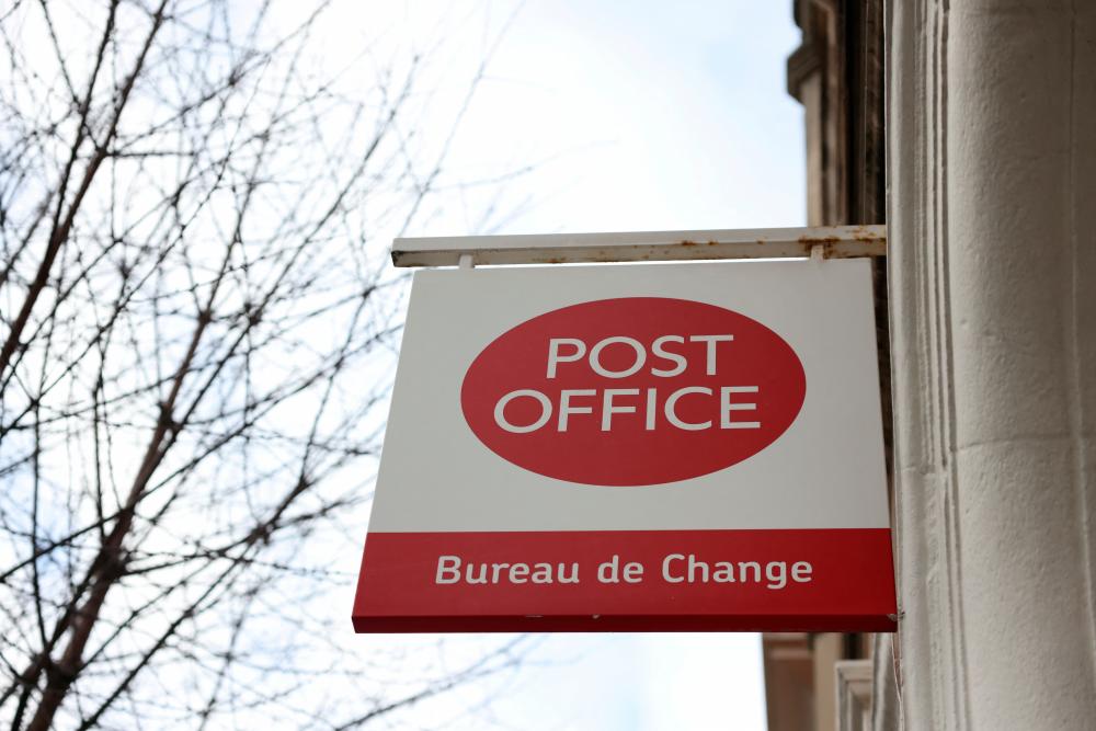 A post office sign hangs above a shop in Belgravia, in London, Britain January 7, 2024/REUTERSPix