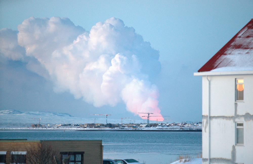 A volcanic eruption is seen in the distance from the Icelandic capital of Reykjavik, Iceland, February 8, 2024/REUTERSPix