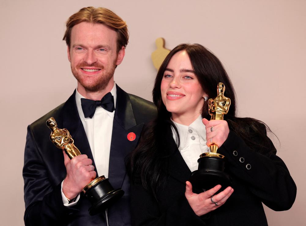 The siblings pose with the Oscar for Best Original Song for What Was I Made For? from Barbie. – REUTERSPIC