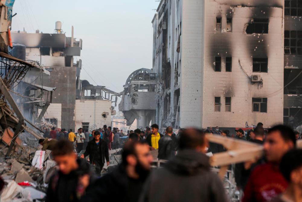 Palestinians inspect damages at Al Shifa Hospital after Israeli forces withdrew from the hospital and the area around it following a two-week operation, amid the ongoing conflict between Israel and Hamas, in Gaza City April 1, 2024/REUTERSPix