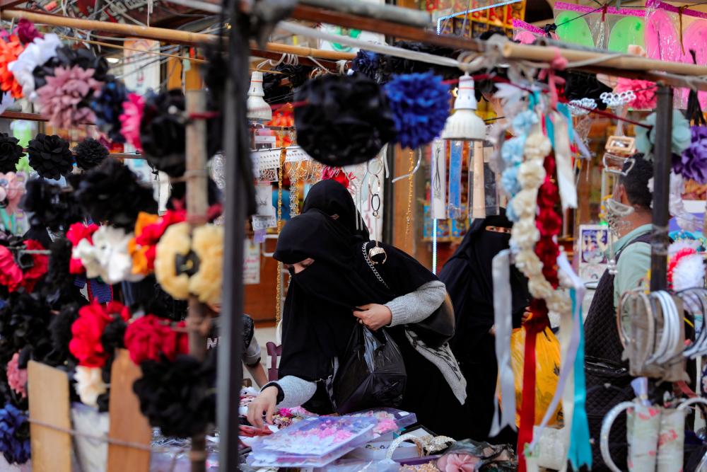 A woman shops for accessories ahead of the Eid al-Fitr celebrations, marking the end of the holy fasting month of Ramadan, in Sanaa, Yemen April 8, 2024. - REUTERSPIX