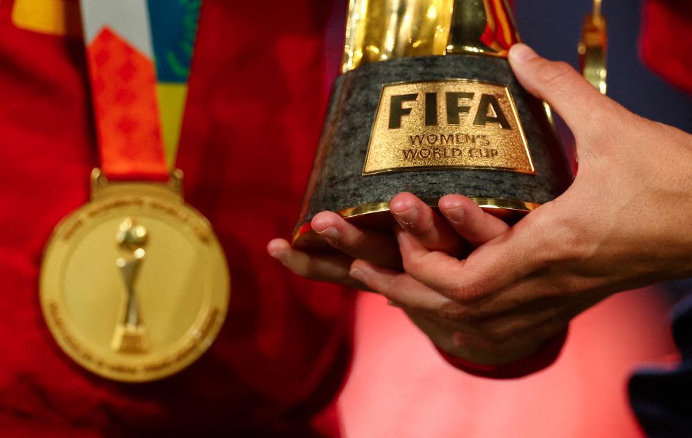 Football - FIFA Women's World Cup Australia and New Zealand 2023 - Final - Spain v England - Stadium Australia, Sydney, Australia - August 20, 2023General view of a Spain player holding the World Cup trophy after the match - REUTERSPIX