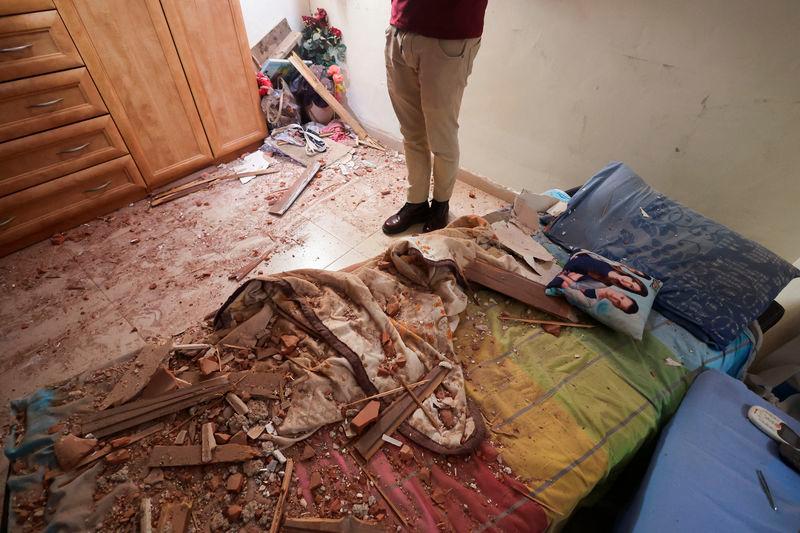 A person stands in a room that was damaged after rockets were fired from the Gaza Strip towards Israel, amid the ongoing conflict in Gaza between Israel and Hamas in Herzliya, Israel - REUTERSpix