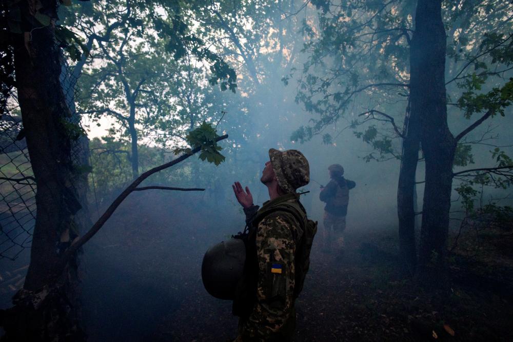 Smoke lingers in the air after a howitzer fired at a Russian position, amid Russia’s attack on Ukraine, at an artillery position of the 57th Motorized Brigade outside Kupiansk, Ukraine, April 21, 2024. - REUTERSPIX