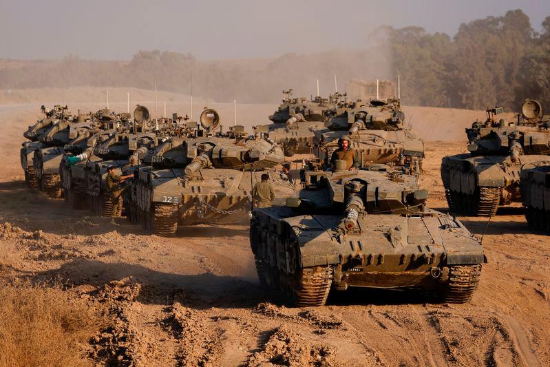 An Israeli soldier stands in a tank, amid the ongoing conflict between Israel and Hamas, near the Israel-Gaza border - REUTERSpix