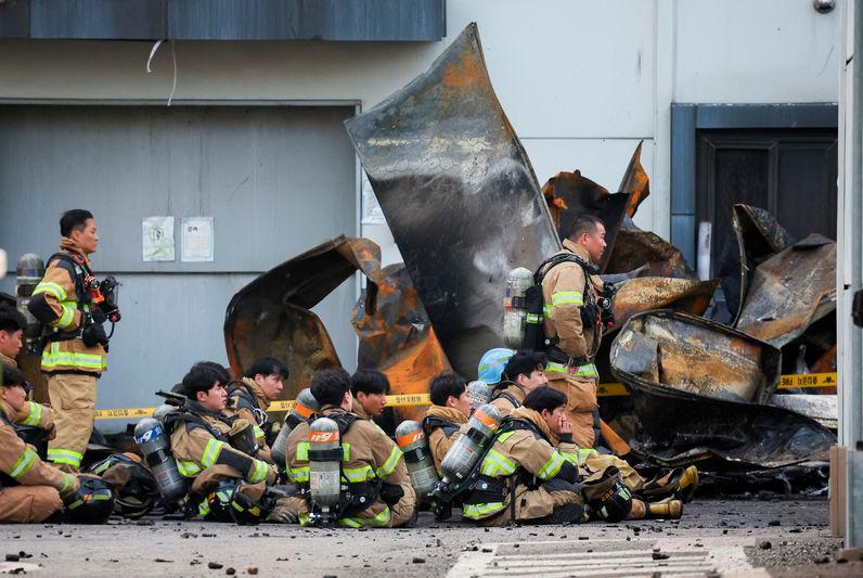 Firefighters take a break as rescue work continues following a deadly fire at a lithium battery factory owned by South Korean battery maker Aricell - REUTERSpix