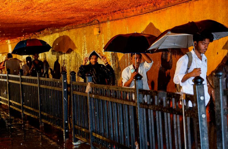 People walk in a waterlogged subway after heavy rains in Mumbai, India - REUTERSpix