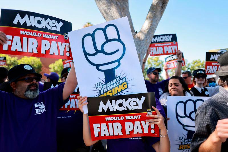 Workers gather with signs as the Teamsters union and Disney cast members demand fair wages at a rally outside Disneyland, in Anaheim, California, U.S., July 17, 2024 / REUTERSpix