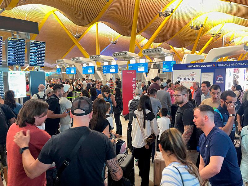 Passengers wait at Barajas Airport, as Spanish airport operator Aena on Friday reported a computer systems incident at all Spanish airports which may cause flight delays, in Madrid, Spain July 19, 2024. REUTERSpix