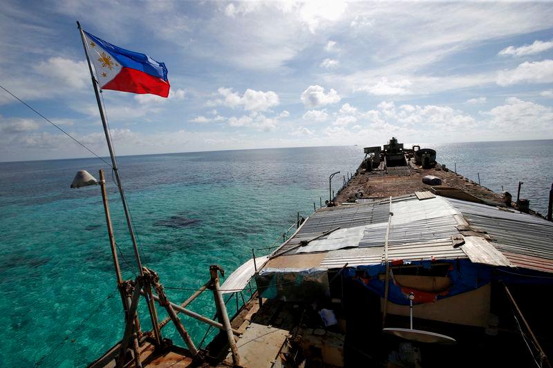 A Philippine flag flutters from a dilapidated Philippine Navy ship that has been aground since 1999 and became a Philippine military detachment on the disputed Second Thomas Shoal, part of the Spratly Islands, in the South China Sea - REUTERSpix