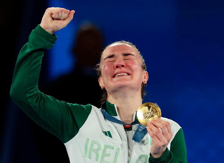 Gold medallist Kellie Harrington of Ireland celebrates on the podium/REUTERS