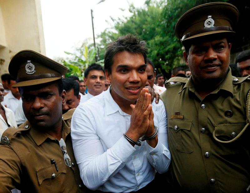 Namal Rajapaksa (C), son of former Sri Lanka’s President Mahinda Rajapaksa, leaves with prison officers at the court after being arrested in Colombo, Sri Lanka July 11, 2016 - REUTERSpix