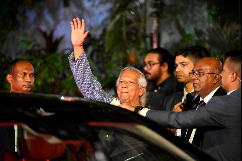 Nobel Peace Prize laureate Muhammad Yunus waves as he leaves his residence to attend the oath taking ceremony to lead an interim government, in Dhaka - REUTERSpix