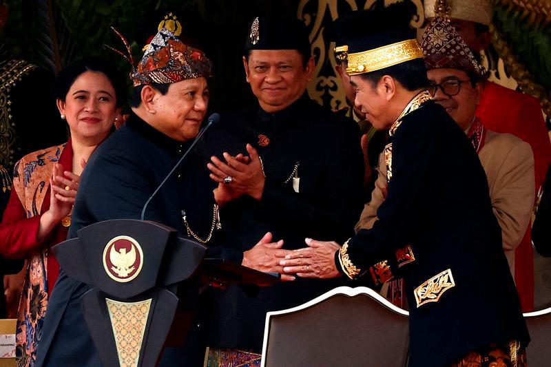 Indonesian President Joko Widodo shakes hands with Defence Minister and President-elect Prabowo Subianto during a ceremony marking the country’s 79th Independence Day at the Presidential Palace in the new capital city of Nusantara, East Kalimantan province - REUTERSpix