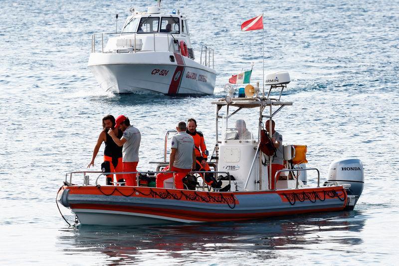 Rescue personnel operate on boats on the sea near the scene where a luxury yacht sank, off the coast of Porticello, near the Sicilian city of Palermo - REUTERSpix