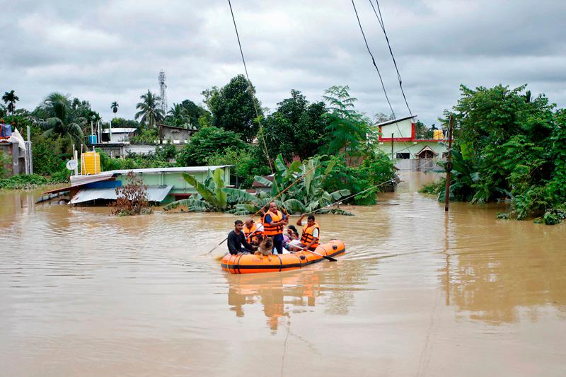 Rescuers from Tripura Disaster Management Authority evacuate flood-affected people to a safer place following heavy rains at a village on the outskirts of Agartala, India, August 22, 2024. REUTERS/Jayanta Dey