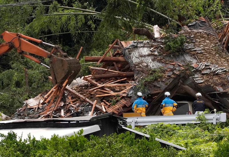 Police officers stand during a rescue operation at an area affected by landfall due to heavy rains caused by Typhoon Shanshan in Gamagori, Aichi prefecture, Japan, August 29, 2024, in this photo taken by Kyodo. - Kyodo/via REUTERS