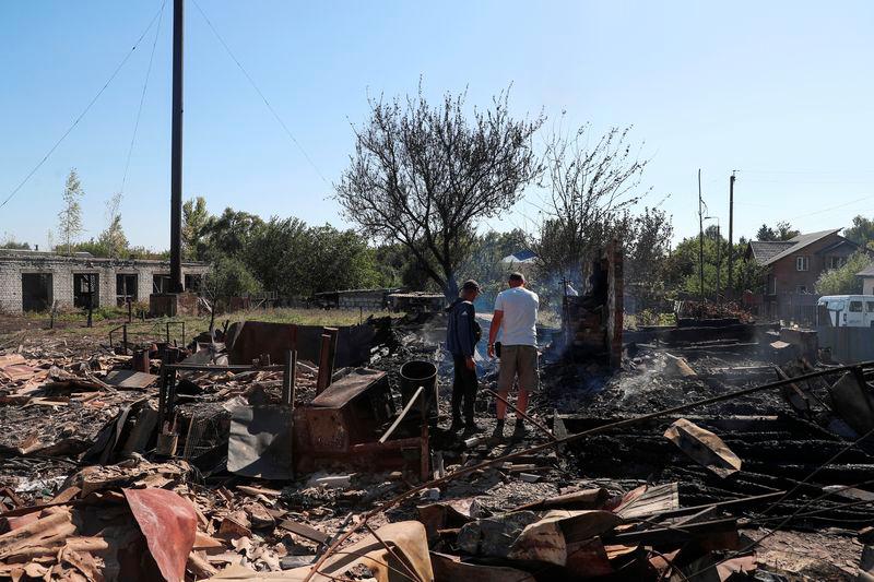 Residents stand at a site of a building destroyed by a Russian military strike, amid Russia's attack on Ukraine, in the village of Yampil, in Sumy region, Ukraine September 6, 2024. - REUTERSPIX