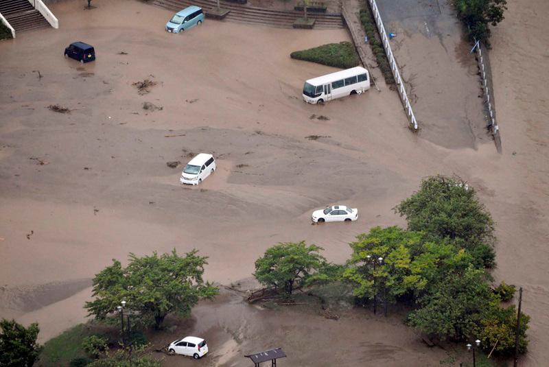 An aerial view taken by a helicopter shows submerged cars caused by a torrential rain at the parking space of the city government office in Wajima, Ishikawa Prefecture, Japan September 21, 2024, in this photo taken by Kyodo. - Kyodo/via REUTERS