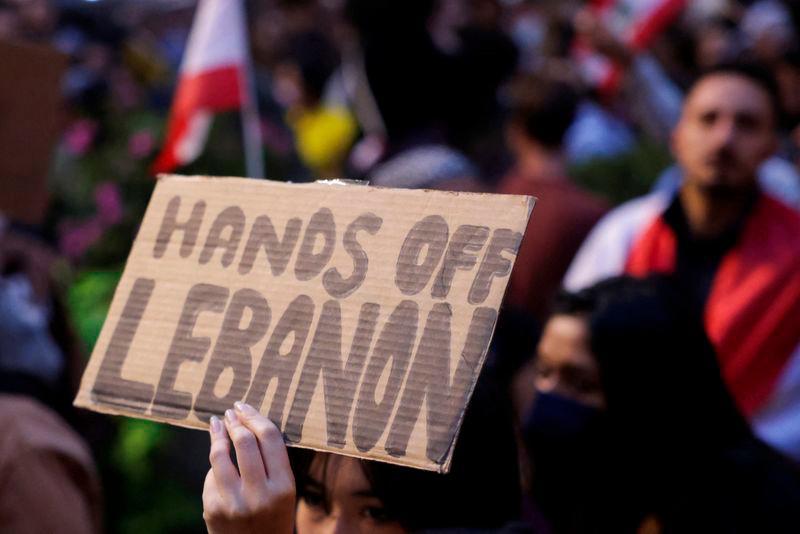 A person holds a sign as people gather to protest the escalation of conflict between Israel and Hezbollah, in New York City - REUTERSpix