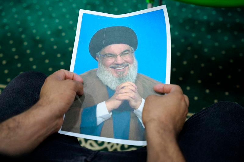 An Iraqi volunteer holds a picture of Lebanon’s Hezbollah leader Sayyed Hassan Nasrallah, who has been killed - REUTERSpix