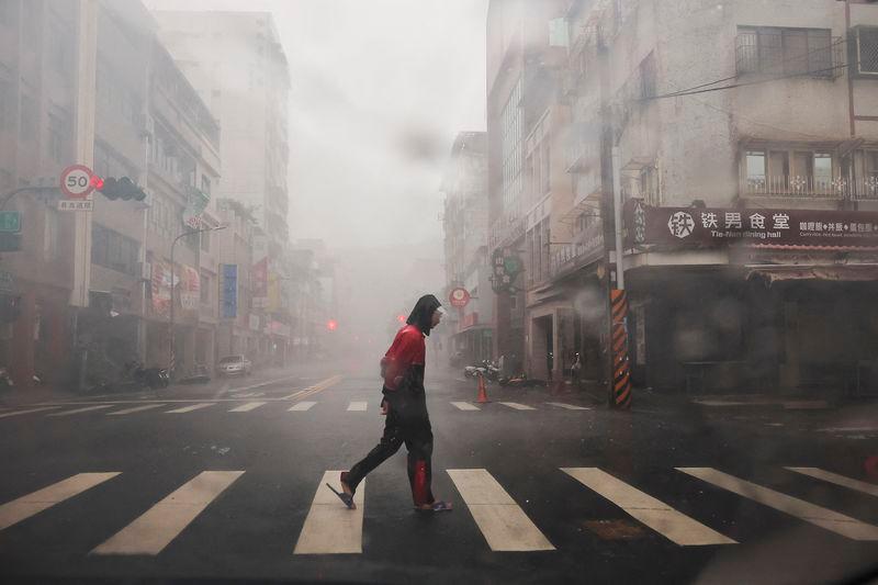 A person crosses the road as Typhoon Krathon approaches, in Kaohsiung, Taiwan. REUTERSPIX