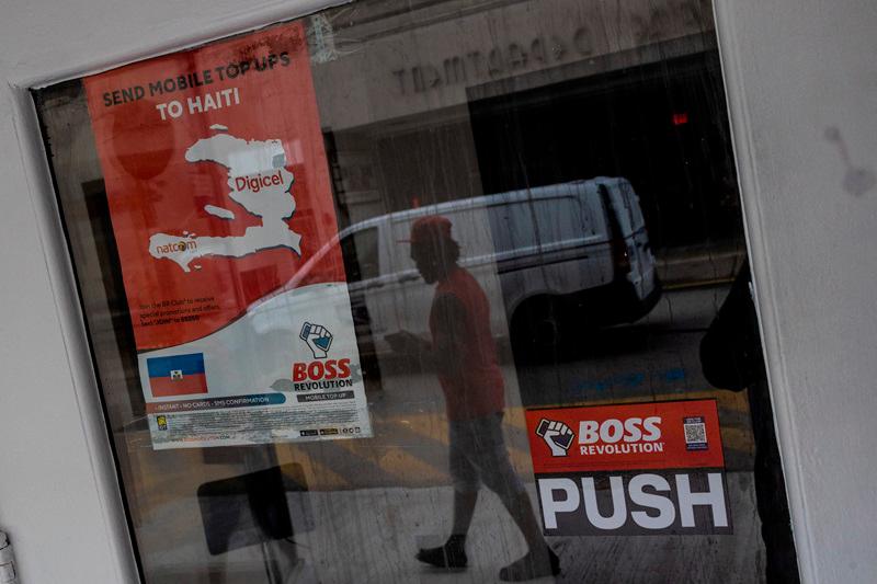 An immigrant from Haiti walks pass a local shop in downtown Charleroi, Pennsylvania, U.S., September 24, 2024. - REUTERS/Carlos Barria