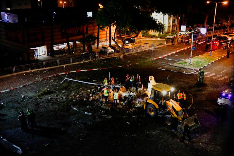 Israeli rescue force members inspect the site where a projectile fell, amid cross-border hostilities between Hezbollah and Israel, in Haifa, northern Israel October 7, 2024. - REUTERS/Shir Torem