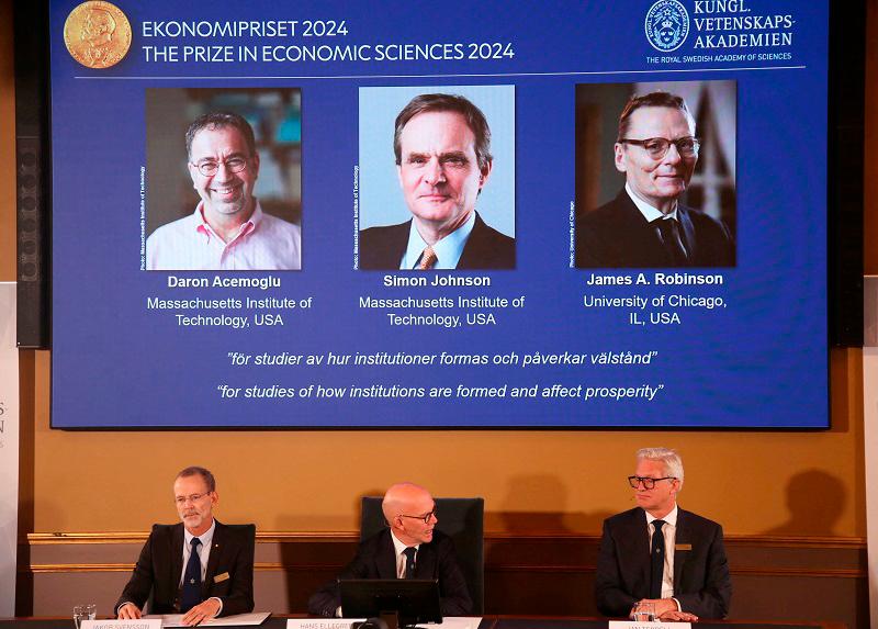 Academy of Sciences permanent secretary Hans Ellegren, Jakob Svensson and Jan Teorell, of the Nobel Assembly at the Swedish Riksbank announce the Swedish Riksbank’s prize in economic science in memory of Alfred Nobel 2024, which goes to Daron Acemoglu, Simon Johnson and James A. Robinson, during a press meeting at the Royal Swedish Academy of Sciences in Stockholm, Sweden, October 14, 2024. - REUTERS/Tom Little