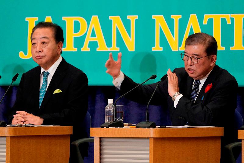 Japan's Prime Minister, Shigeru Ishiba, leader of the Liberal Democratic Party speaks beside Yoshihiko Noda, leader of the Constitutional Democratic Party during the debate at the Japan National Press Club in Tokyo, Japan October 12, 2024. - Eugene Hoshiko/Pool via REUTERS/File Photo