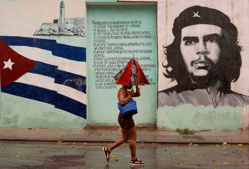 A woman walks on the street as Hurricane Rafael passes by Havana - REUTERSpix