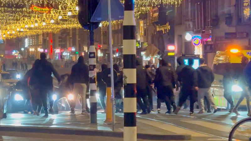 Israeli football supporters and Dutch youth clash near Amsterdam Central station, in Amsterdam, Netherlands, November 8, 2024, in this still image obtained from a social media video. - X/iAnnet/via REUTERS