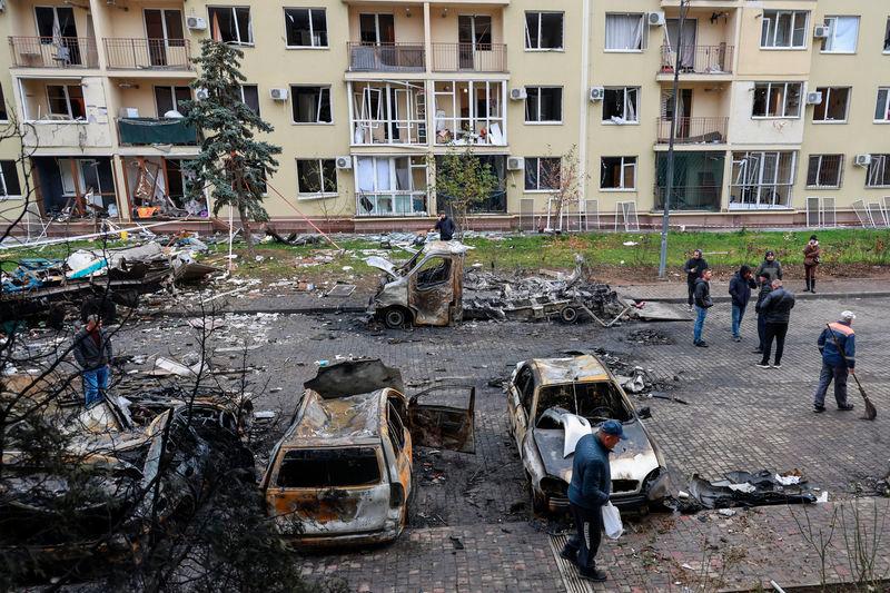 Residents gather next to their destroyed cars and a damaged apartment building hit by a Russian drone strike, amid Russia’s attack on Ukraine - REUTERSpix