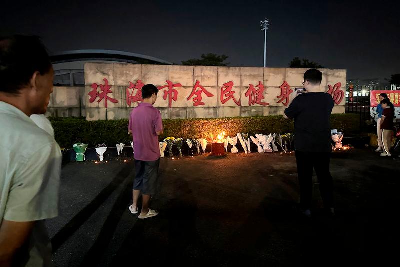 Candles and floral tributes are laid outside a sports centre where a deadly hit-and-run attack took place, in Zhuhai, Guangdong province - REUTERSpix