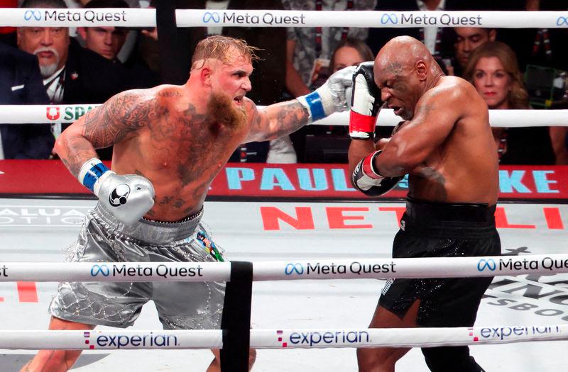 Mike Tyson (black gloves) fights Jake Paul (silver gloves) at AT&amp;T Stadium - REUTERSpix