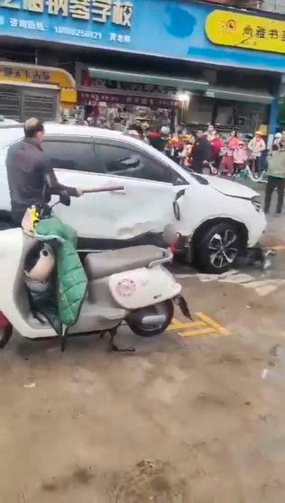 A police officer handcuffs a man on the ground following a vehicle collision outside a primary school in Changde, Hunan province, China in this screengrab obtained from social media video released November 19, 2024. Reuterspix