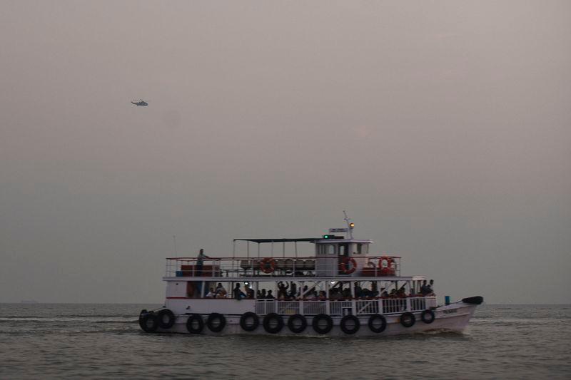 A military helicopter flies over a ferry during a rescue operation after a passenger boat capsized off the coast of India’s financial capital Mumbai - REUTERS/Stringer