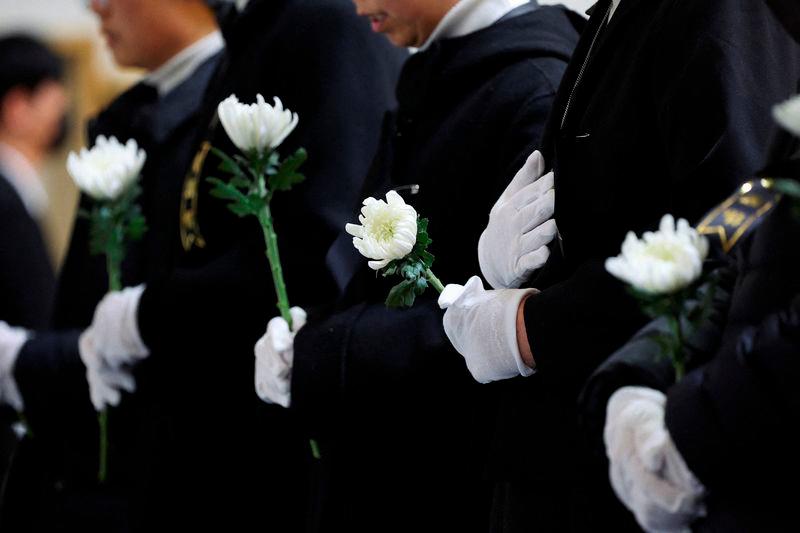 Nuns pray at a memorial altar for the victims of the Jeju Air crash at Muan International Airport, at Muan Sports Park in Muan - REUTERSpix