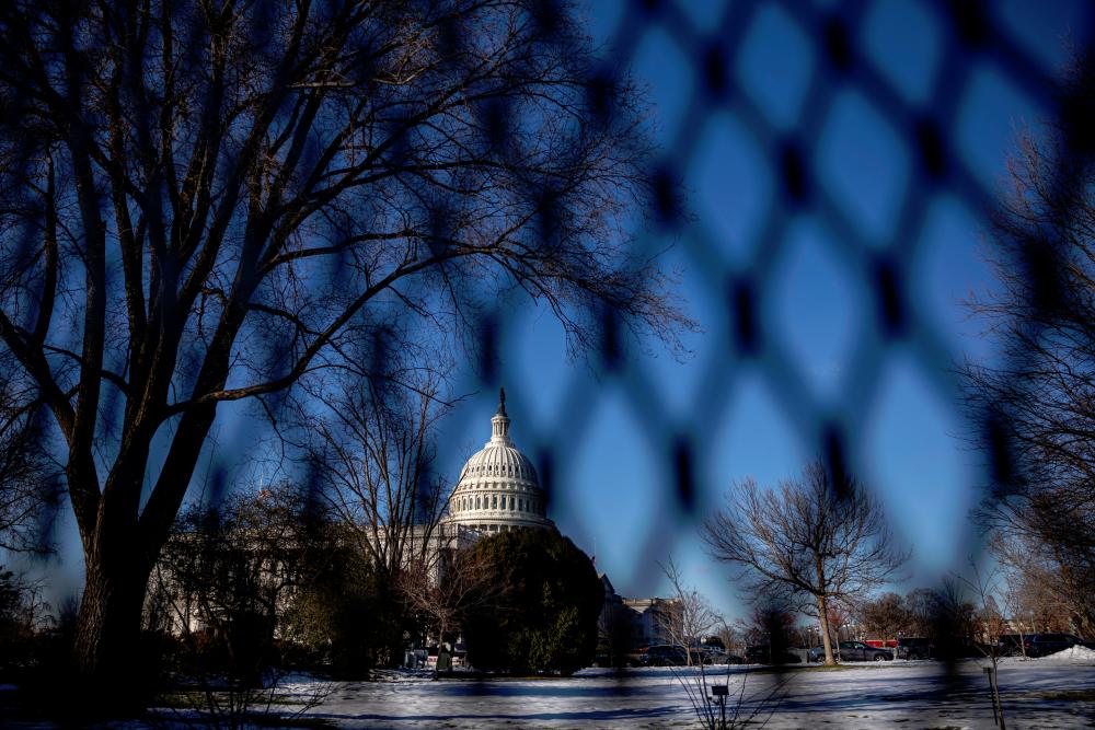 The U.S. Capitol building is seen through a security fencing, ahead of the presidential inauguration of U.S. President-elect Donald Trump, in Washington, U.S. - REUTERSpix