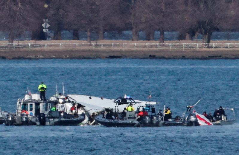 Pix for visual purposes. Emergency workers recover debris from the Potomac River in the aftermath of the collision of American Eagle flight 5342 and a Black Hawk helicopter, as seen from Virginia, U.S., January 30, 2025. REUTERSpix/Carlos Barria