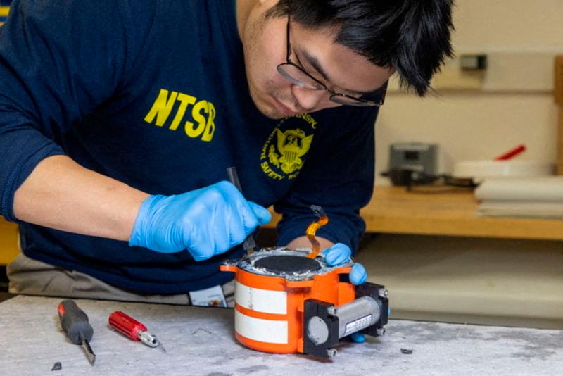 An NTSB investigator works on the black box of American Eagle flight 5342, which was involved in a collision with a Black Hawk helicopter, at an unknown location in this undated handout image released on January 30, 2025. NTSB/Handout via REUTERSpix